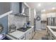 Modern kitchen features a stylish backsplash, stainless steel appliances, and a cooktop at 17212 Balance Cv, Land O Lakes, FL 34638