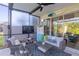 Cozy screened lanai with comfortable wicker furniture, a ceiling fan, and view of the backyard at 17212 Balance Cv, Land O Lakes, FL 34638