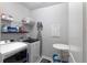 Bright laundry room with modern washer and dryer, storage shelves, and a folding table at 17212 Balance Cv, Land O Lakes, FL 34638