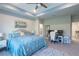 Spacious main bedroom with a work space, a luxurious bed, and serene decor at 17212 Balance Cv, Land O Lakes, FL 34638