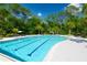 An inviting community pool with lap lanes and ample deck space, surrounded by lush landscaping at 17212 Balance Cv, Land O Lakes, FL 34638