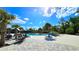 A resort-style community pool with a splash pad, seating, and ample deck space for residents to relax and enjoy at 17212 Balance Cv, Land O Lakes, FL 34638