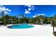 Community pool features a resort-style pool, splash pad, seating, and lush landscaping for residents at 17212 Balance Cv, Land O Lakes, FL 34638