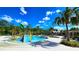 A dynamic splash pad and pool area for residents, with lush landscaping and seating for relaxation at 17212 Balance Cv, Land O Lakes, FL 34638