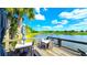 A charming porch features a serene lake view, two tables, and seating for residents to relax at 17212 Balance Cv, Land O Lakes, FL 34638