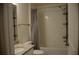 Modern bathroom featuring a granite vanity top, sink and a shower/tub with gray chevron curtain at 17833 Althea Blue Pl, Lutz, FL 33558