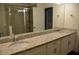 Bathroom featuring double granite vanity, framed mirror, and large glass shower at 17833 Althea Blue Pl, Lutz, FL 33558