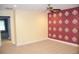 Bedroom with a ceiling fan and a red accent wall at 17833 Althea Blue Pl, Lutz, FL 33558