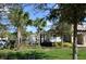 View of community landscaping with lawn, trees, sidewalks and private residences at 17833 Althea Blue Pl, Lutz, FL 33558