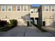 Inviting townhome featuring a well-maintained exterior, attached garages, and a charming entrance with landscaped accents at 17833 Althea Blue Pl, Lutz, FL 33558