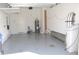 Spacious two-car garage with clean epoxy flooring, providing a functional and tidy storage area at 17833 Althea Blue Pl, Lutz, FL 33558