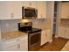 Modern kitchen featuring stainless steel appliances, sleek white cabinets, granite counters, and a stylish tiled backsplash at 17833 Althea Blue Pl, Lutz, FL 33558