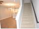 Open floor plan with stairs leading to the upper level, bright with natural light at 17833 Althea Blue Pl, Lutz, FL 33558