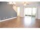 Bright living room features stylish floors, a ceiling fan, sliding glass doors and neutral paint at 17833 Althea Blue Pl, Lutz, FL 33558