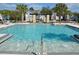 Inviting community pool with clear blue water, sun loungers, and seating areas for residents' relaxation at 17833 Althea Blue Pl, Lutz, FL 33558