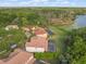 Aerial view of residences nestled on a tree-lined lot, each with screened in-ground pools and access to the lake at 1804 Bella Casa Ct, Tampa, FL 33618