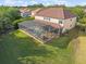 Aerial view of a home with a screened pool, patio, and spacious backyard, ideal for outdoor living at 1804 Bella Casa Ct, Tampa, FL 33618