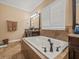 Spacious bathroom featuring a white garden tub and dark wood cabinetry at 1804 Bella Casa Ct, Tampa, FL 33618