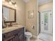 Well lit bathroom featuring a single sink vanity with granite countertop and a standing shower at 1804 Bella Casa Ct, Tampa, FL 33618