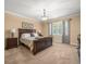 This bedroom offers neutral colored walls and carpet, and a chandelier light fixture at 1804 Bella Casa Ct, Tampa, FL 33618