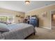 Neutral bedroom with dark wood furniture, window and a sitting chair at 1804 Bella Casa Ct, Tampa, FL 33618