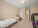 Neutral bedroom with a small bed, treadmill, and beige carpet at 1804 Bella Casa Ct, Tampa, FL 33618