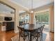 Dining room with wood table and chairs, light fixture and view of the pool at 1804 Bella Casa Ct, Tampa, FL 33618