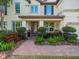 Inviting front entrance with brick walkway, well-maintained landscaping, and covered entry at 1804 Bella Casa Ct, Tampa, FL 33618