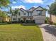 Beautiful two-story home with a well-manicured lawn and mature landscaping and a tile roof at 1804 Bella Casa Ct, Tampa, FL 33618