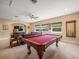 Entertaining game room area with a pool table, comfortable seating, and plenty of natural light at 1804 Bella Casa Ct, Tampa, FL 33618