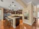 Elegant kitchen with wood floors, granite counters, stainless appliances, breakfast bar and dark wood cabinets at 1804 Bella Casa Ct, Tampa, FL 33618