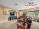Cozy living room with comfortable leather seating, a large TV, and natural light from the windows at 1804 Bella Casa Ct, Tampa, FL 33618