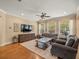 Open living room with hardwood floors, ceiling fan, and view of the backyard at 1804 Bella Casa Ct, Tampa, FL 33618