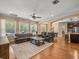 Spacious living room features wood floors, a ceiling fan and an archway leading to the kitchen at 1804 Bella Casa Ct, Tampa, FL 33618