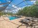 Screened in pool with patio furniture and fountain features at 1804 Bella Casa Ct, Tampa, FL 33618