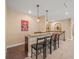 Home wet bar complete with tile floors, bar counter, dark wooden cabinets and barstool seating at 1804 Bella Casa Ct, Tampa, FL 33618
