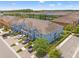 Aerial view of a townhome community, showcasing the property's proximity to a pond at 18872 Noble Caspian Dr, Lutz, FL 33558