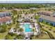 Aerial view of the community clubhouse, pool, and recreational facilities, surrounded by lush trees at 18872 Noble Caspian Dr, Lutz, FL 33558