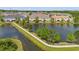 Aerial view of the community featuring a pond, walking path, and lush landscaping at 18872 Noble Caspian Dr, Lutz, FL 33558