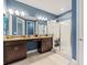 Modern bathroom with double vanity, granite countertops, and glass-enclosed shower at 18872 Noble Caspian Dr, Lutz, FL 33558