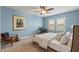 Light blue bedroom featuring neutral colored furniture, ceiling fan, and plantation shutters at 18872 Noble Caspian Dr, Lutz, FL 33558
