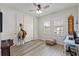 Clean, neutral bedroom features a ceiling fan, plantation shutters, and light-colored wood floors at 18872 Noble Caspian Dr, Lutz, FL 33558