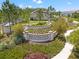 Beautiful Sylvan Crossing community entrance with lush landscaping, trees, and manicured lawns at 18872 Noble Caspian Dr, Lutz, FL 33558