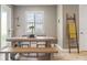 Dining area with a rustic table, bench seating, and natural light at 18872 Noble Caspian Dr, Lutz, FL 33558