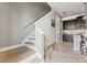 Entryway with stairs and view into the kitchen with tile floors and granite countertops at 18872 Noble Caspian Dr, Lutz, FL 33558