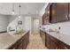 A modern kitchen featuring dark wood cabinets, granite countertops, and stainless steel appliances at 18872 Noble Caspian Dr, Lutz, FL 33558