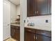 Kitchen area with dark wood cabinets, granite countertops, and tiled backsplash at 18872 Noble Caspian Dr, Lutz, FL 33558