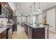 Open kitchen features granite countertops, stainless steel appliances, and views into the living area at 18872 Noble Caspian Dr, Lutz, FL 33558