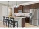 Bright kitchen features granite countertops, a stainless steel refrigerator, and dark wood cabinetry at 18872 Noble Caspian Dr, Lutz, FL 33558