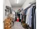 Well-organized walk-in closet with shelves, hanging rods, and ample storage space for clothes and accessories at 18872 Noble Caspian Dr, Lutz, FL 33558